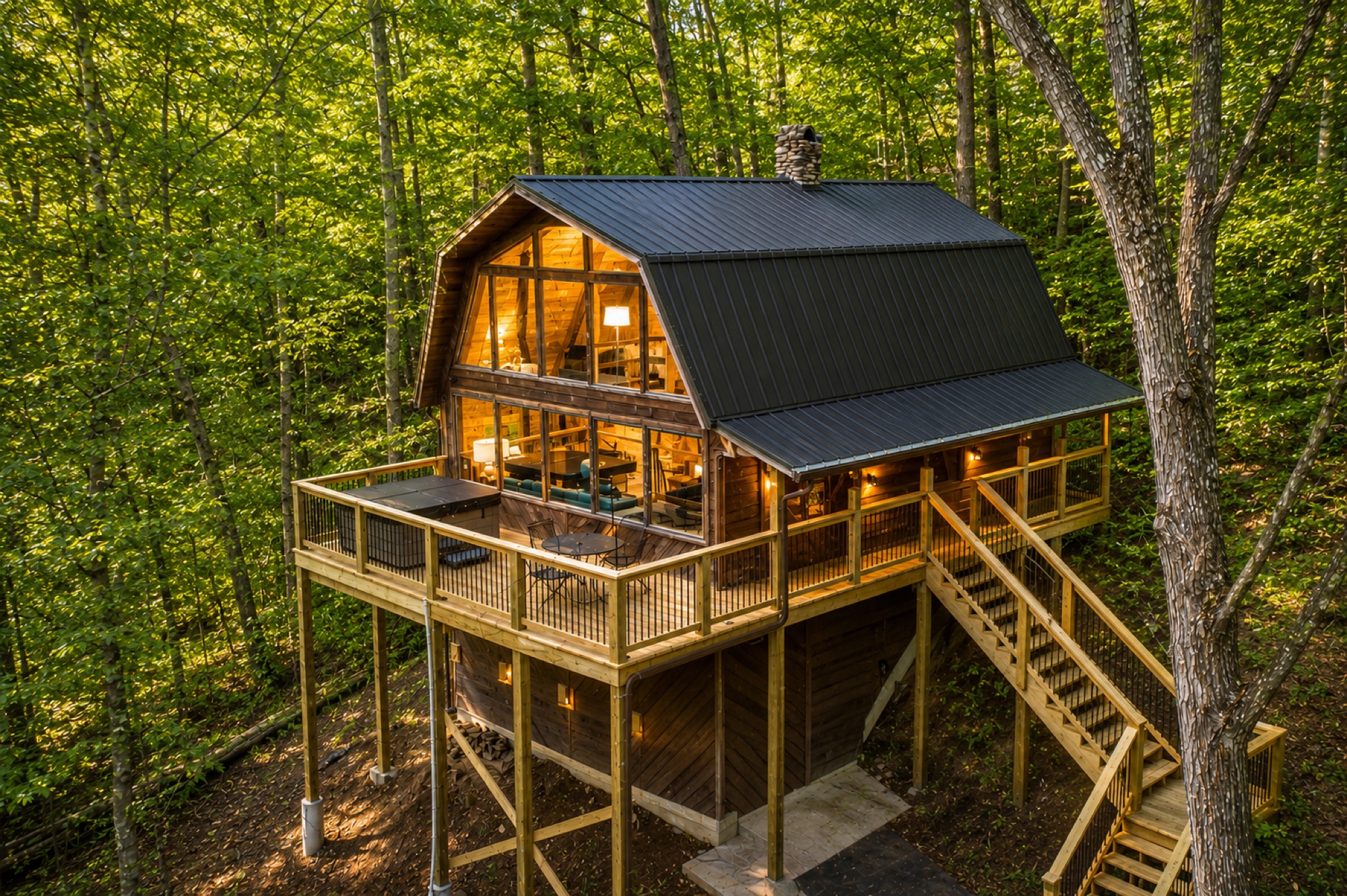 Twilight aerial view of Rustic Retreat's A frame exterior and wraparound deck