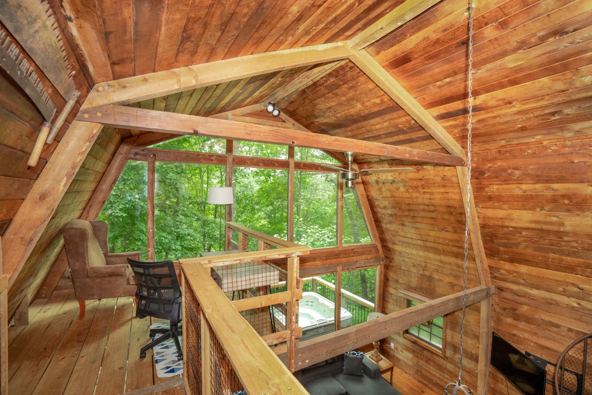 Loft workspace at Rustic Retreat overlooking the deck and hot tub below
